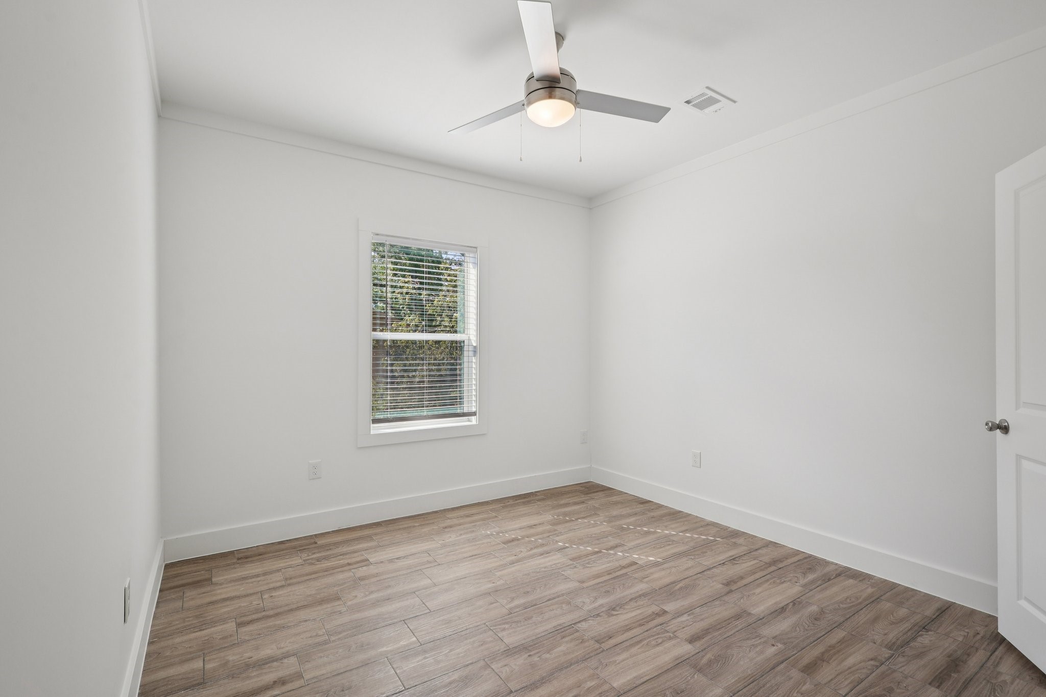 3917 Sayers Street Houston, TX 77026 - Photo 17 of 26 wooden floor in an empty room with a window