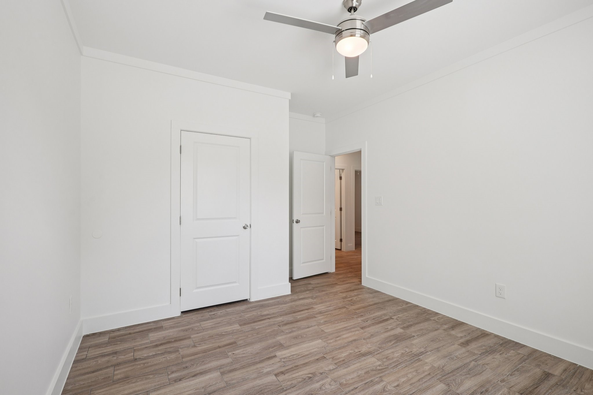 3917 Sayers Street Houston, TX 77026 - Photo 19 of 26 an empty room with wooden floor ceiling fan and window
