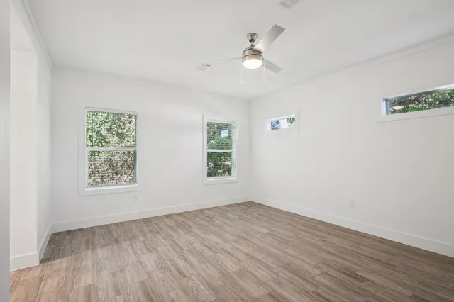 wooden floor in an empty room with a window