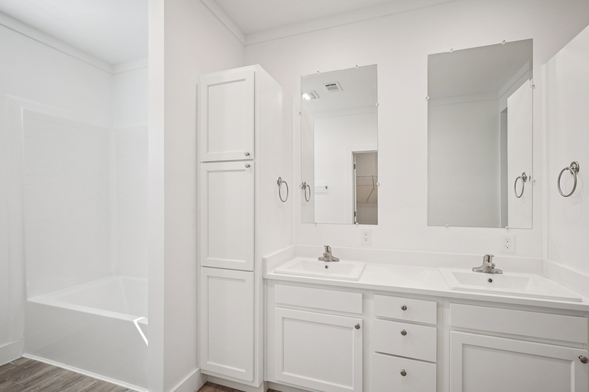 3917 Sayers Street Houston, TX 77026 - Photo 25 of 26 a bathroom with a double vanity sink a mirror and a bathtub