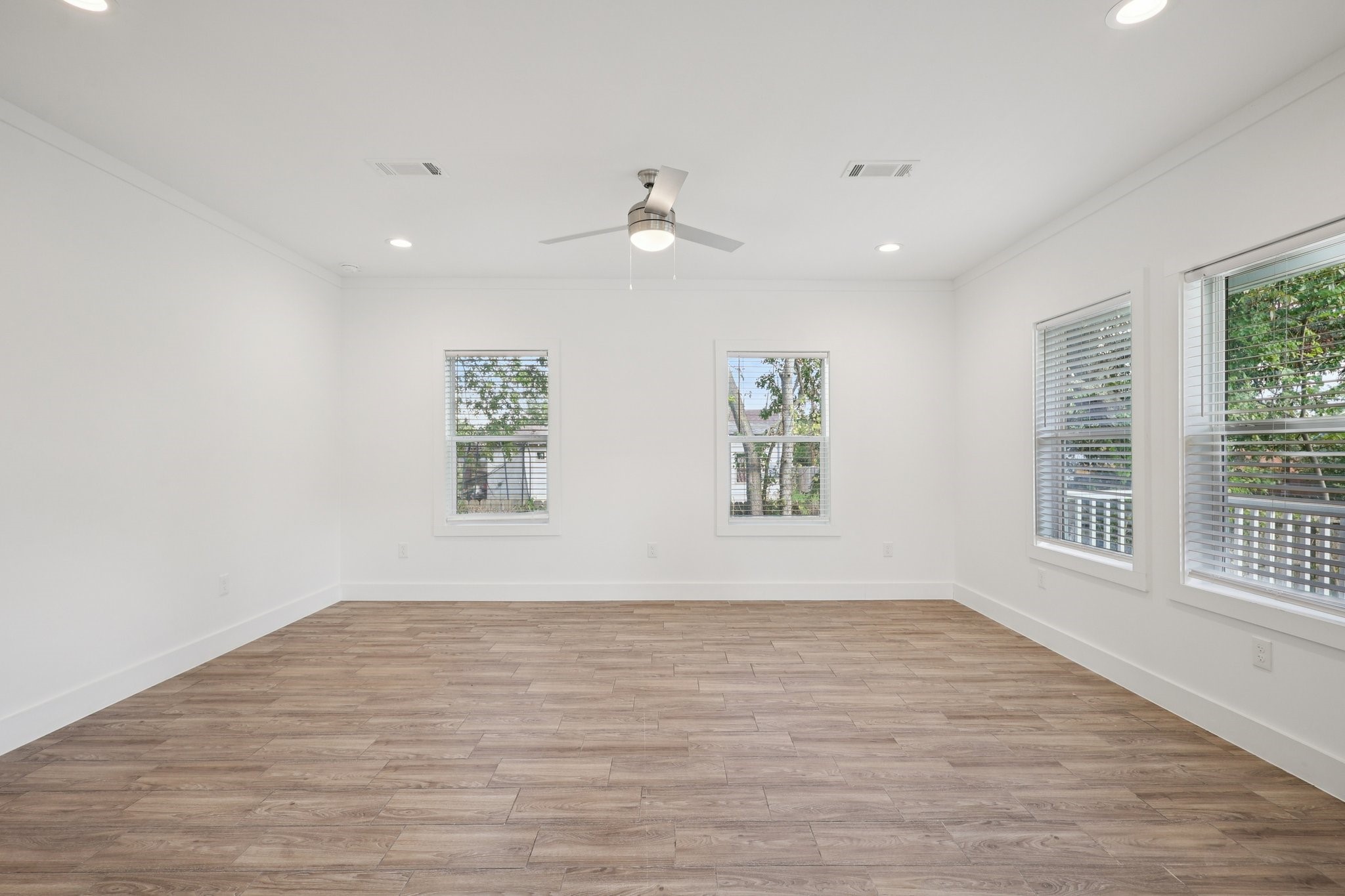 3917 Sayers Street Houston, TX 77026 - Photo 4 of 26 an empty room with wooden floor and windows