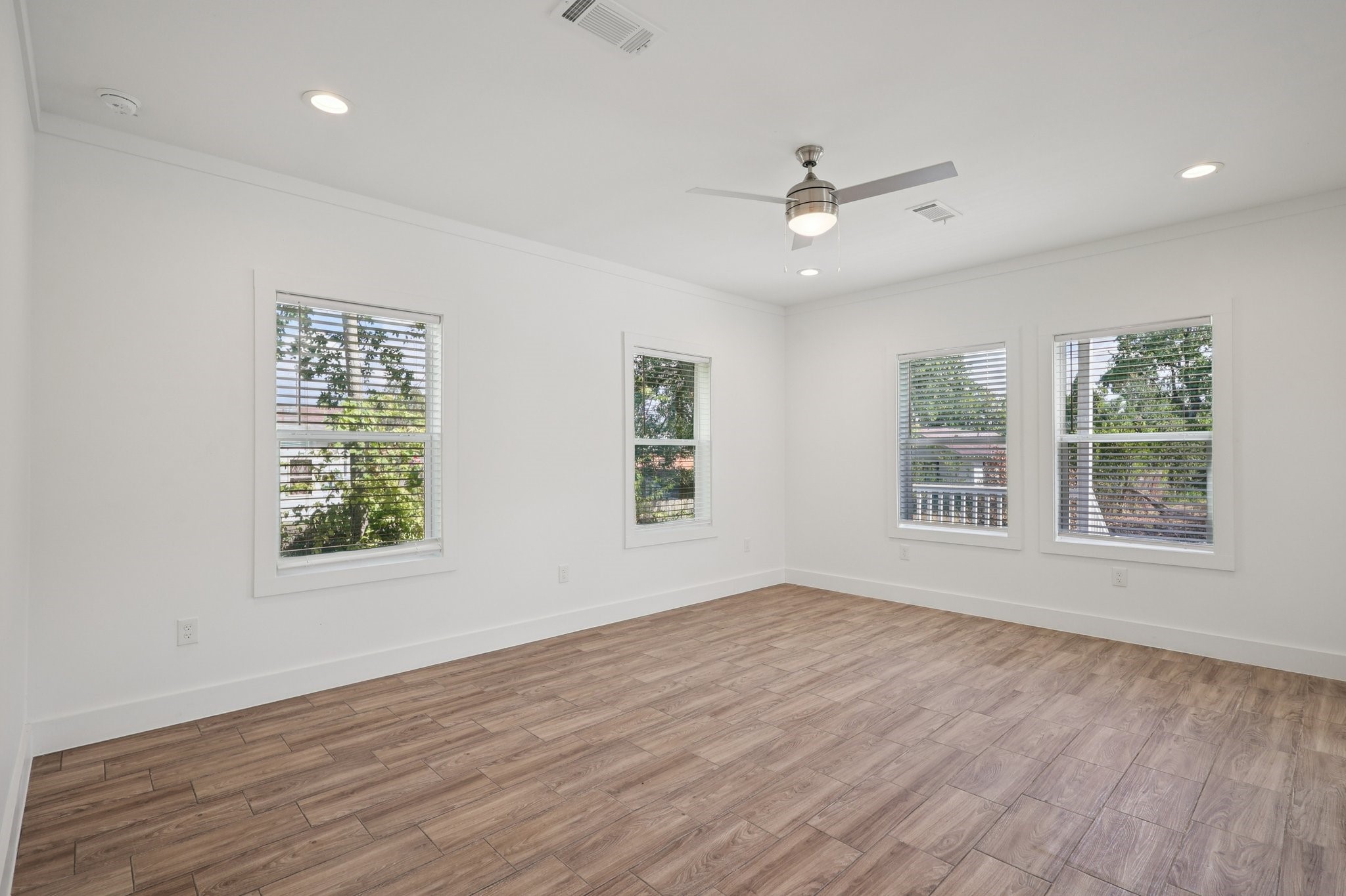 3917 Sayers Street Houston, TX 77026 - Photo 6 of 26 a view of an empty room with wooden floor and a window