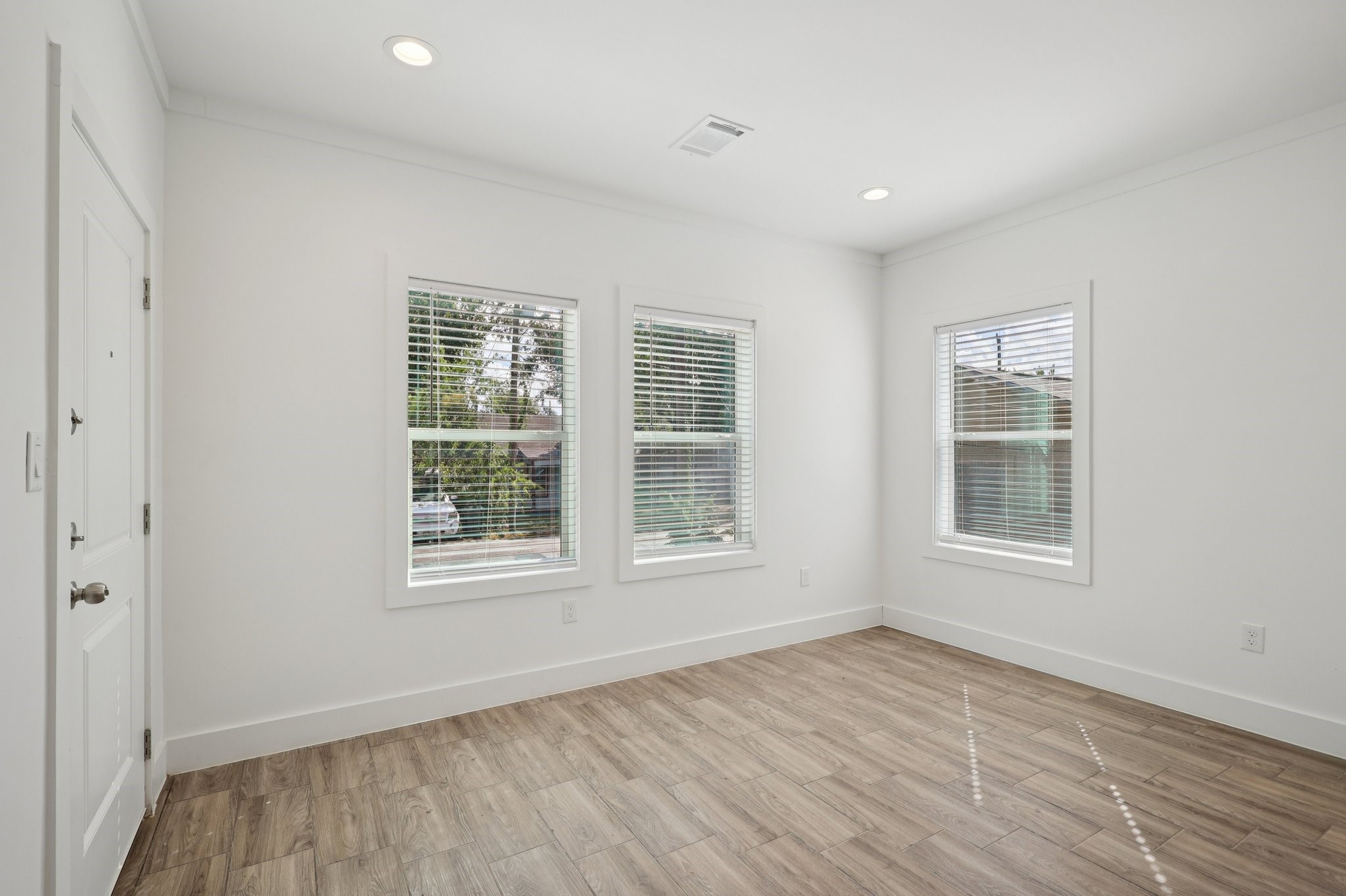 3917 Sayers Street Houston, TX 77026 - Photo 7 of 26 an empty room with wooden floor and windows