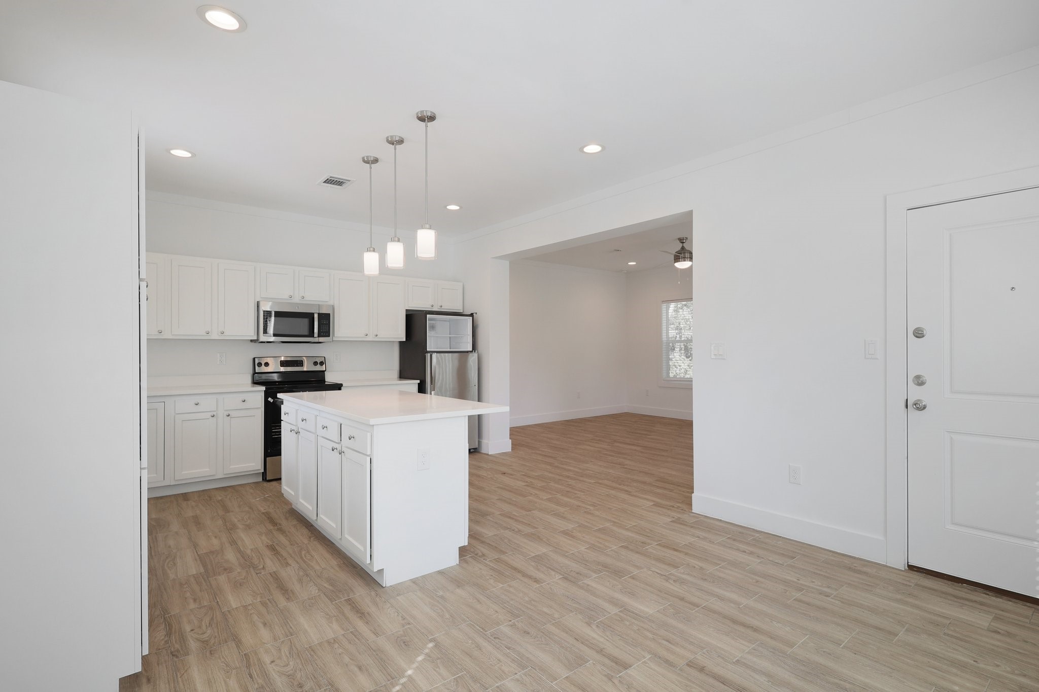 3917 Sayers Street Houston, TX 77026 - Photo 9 of 26 a view of kitchen with kitchen island a refrigerator and a stove top oven