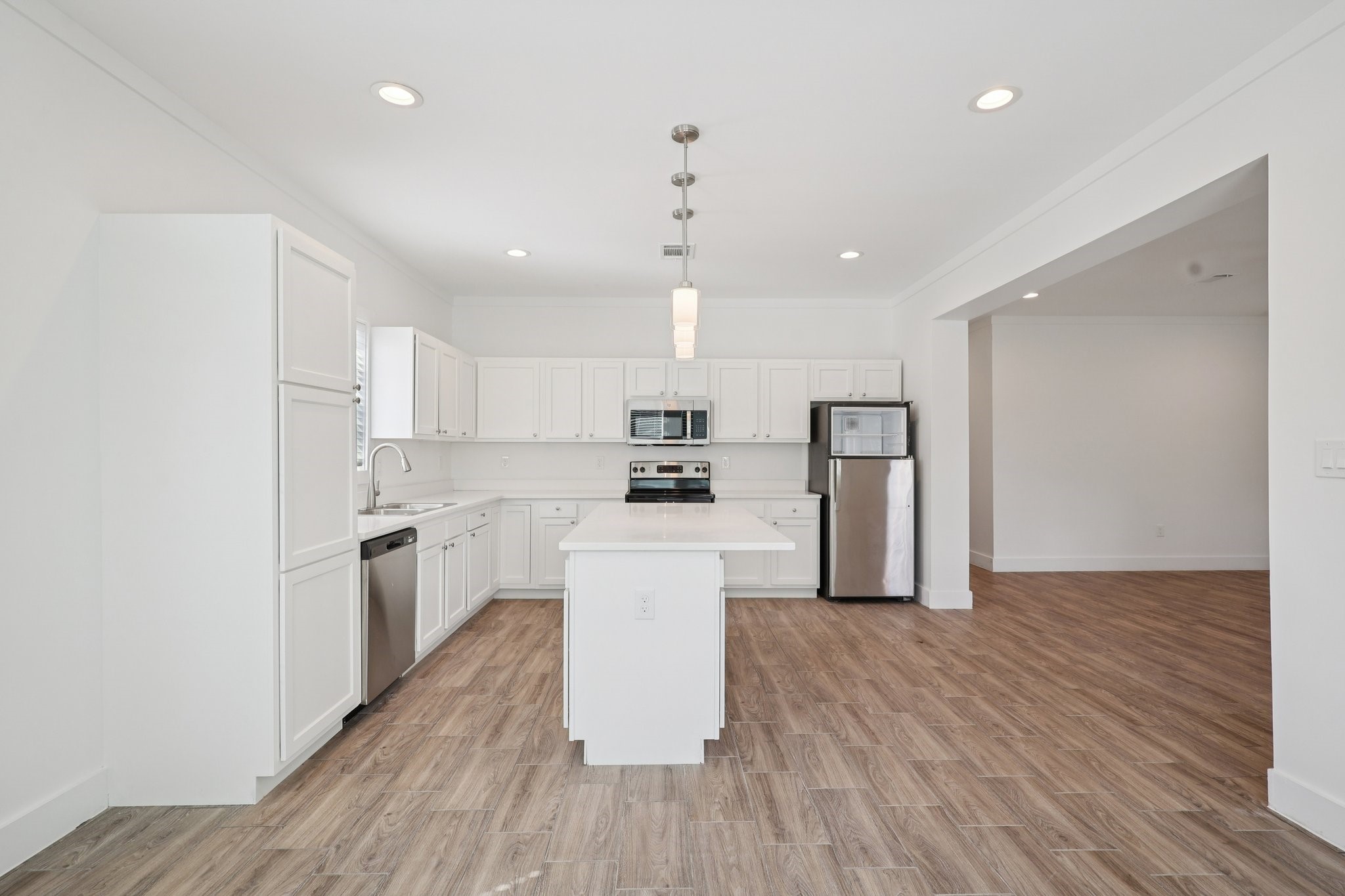 3917 Sayers Street Houston, TX 77026 - Photo 10 of 26 a kitchen with refrigerator cabinets and wooden floor