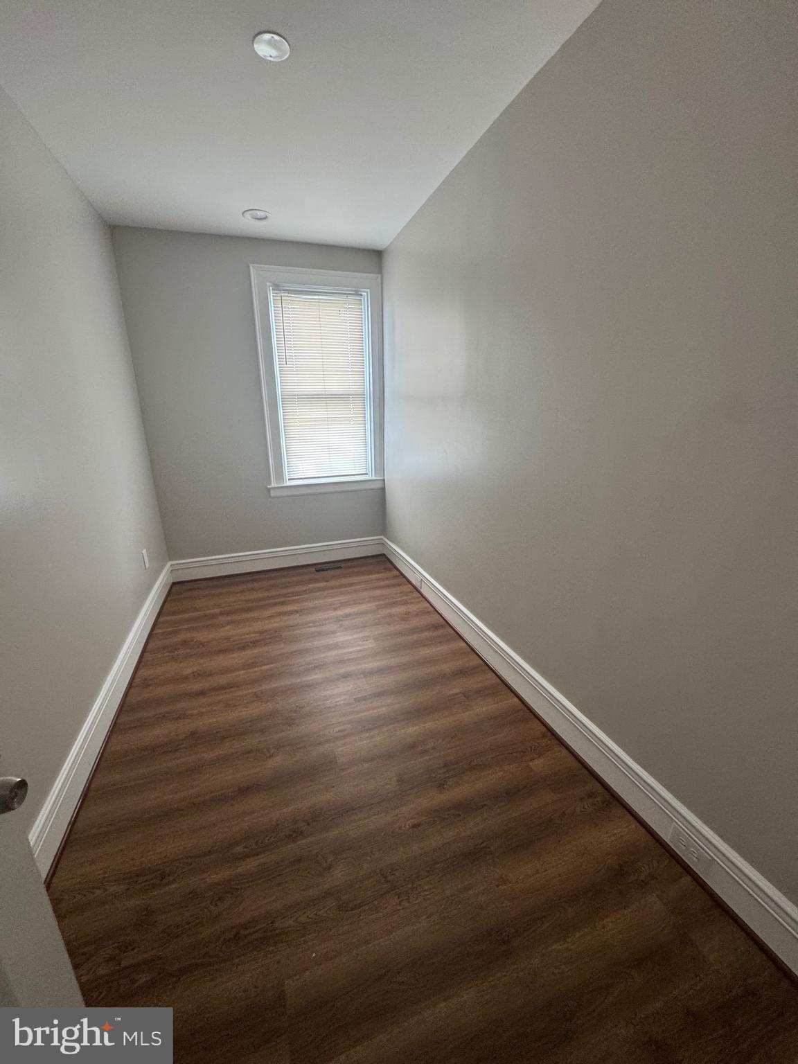 2613 Maisel Street Baltimore, MD 21230 - Photo 11 of 15 an empty room with wooden floor and windows