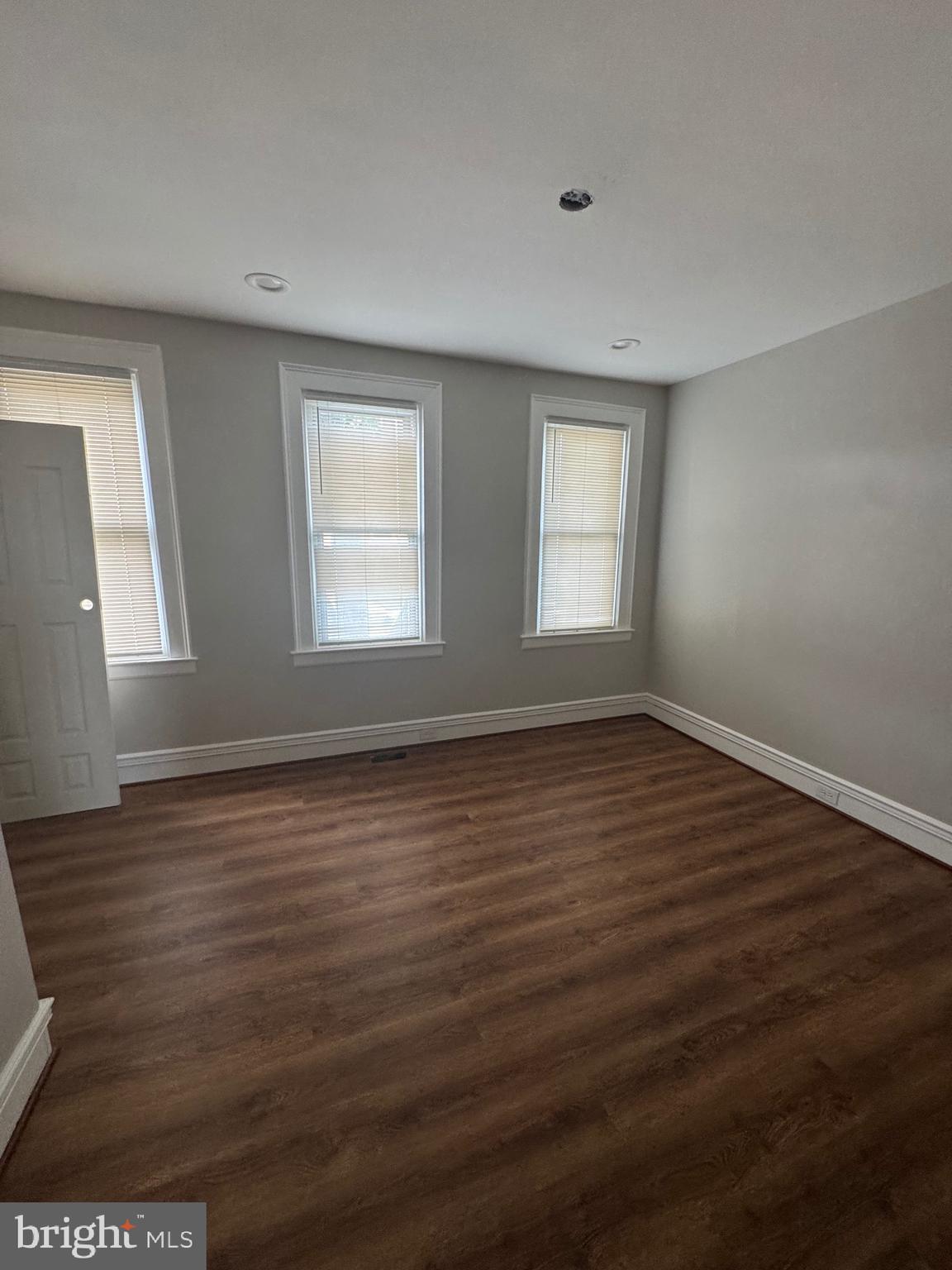 2613 Maisel Street Baltimore, MD 21230 - Photo 12 of 15 an empty room with wooden floor and windows