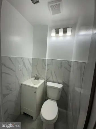 a white toilet sitting next to a bathroom sink