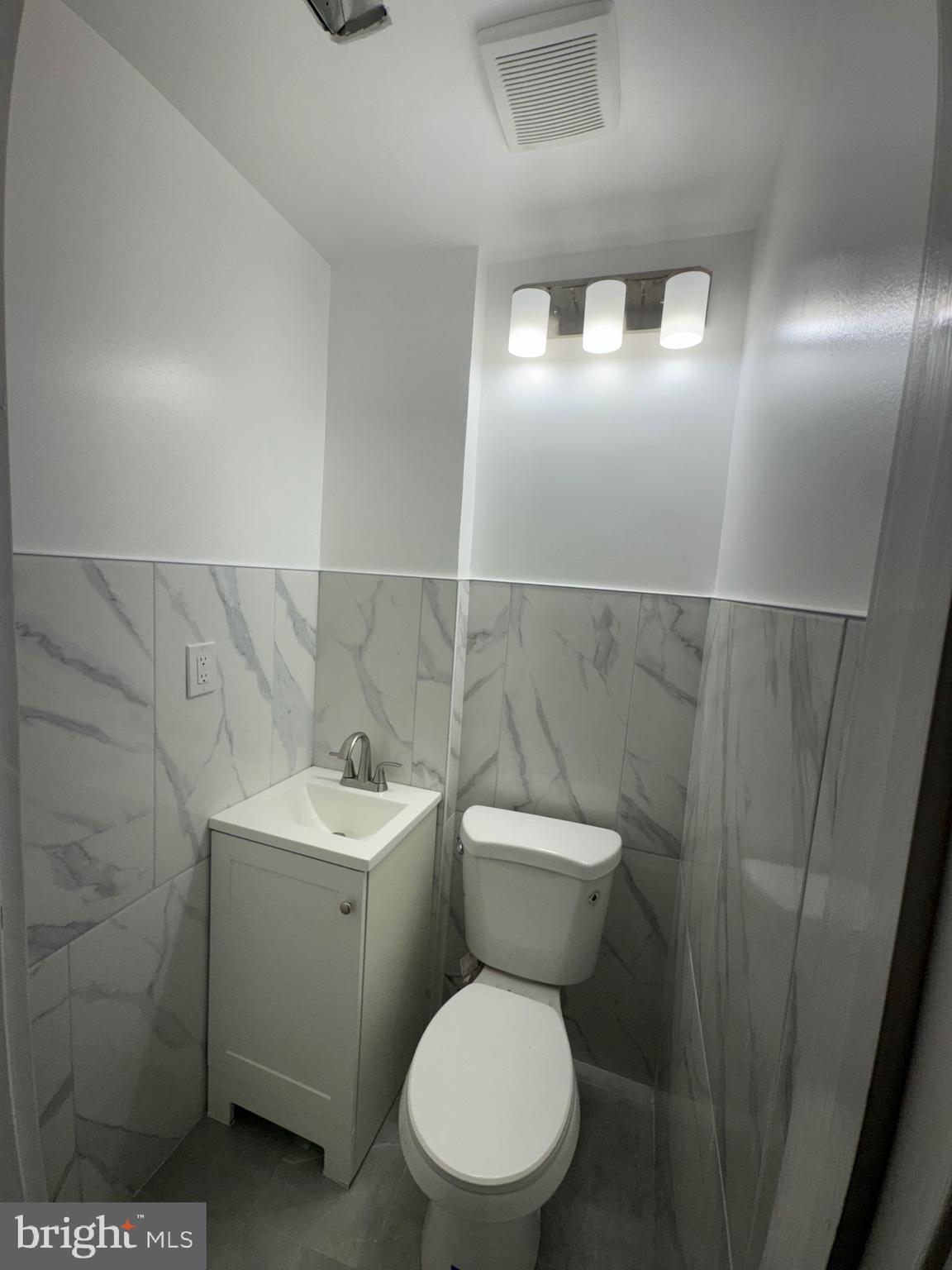 2613 Maisel Street Baltimore, MD 21230 - Photo 14 of 15 a white toilet sitting next to a bathroom sink