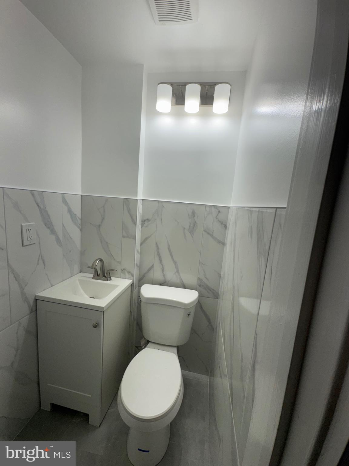 2613 Maisel Street Baltimore, MD 21230 - Photo 15 of 15 a bathroom with a toilet sink and mirror