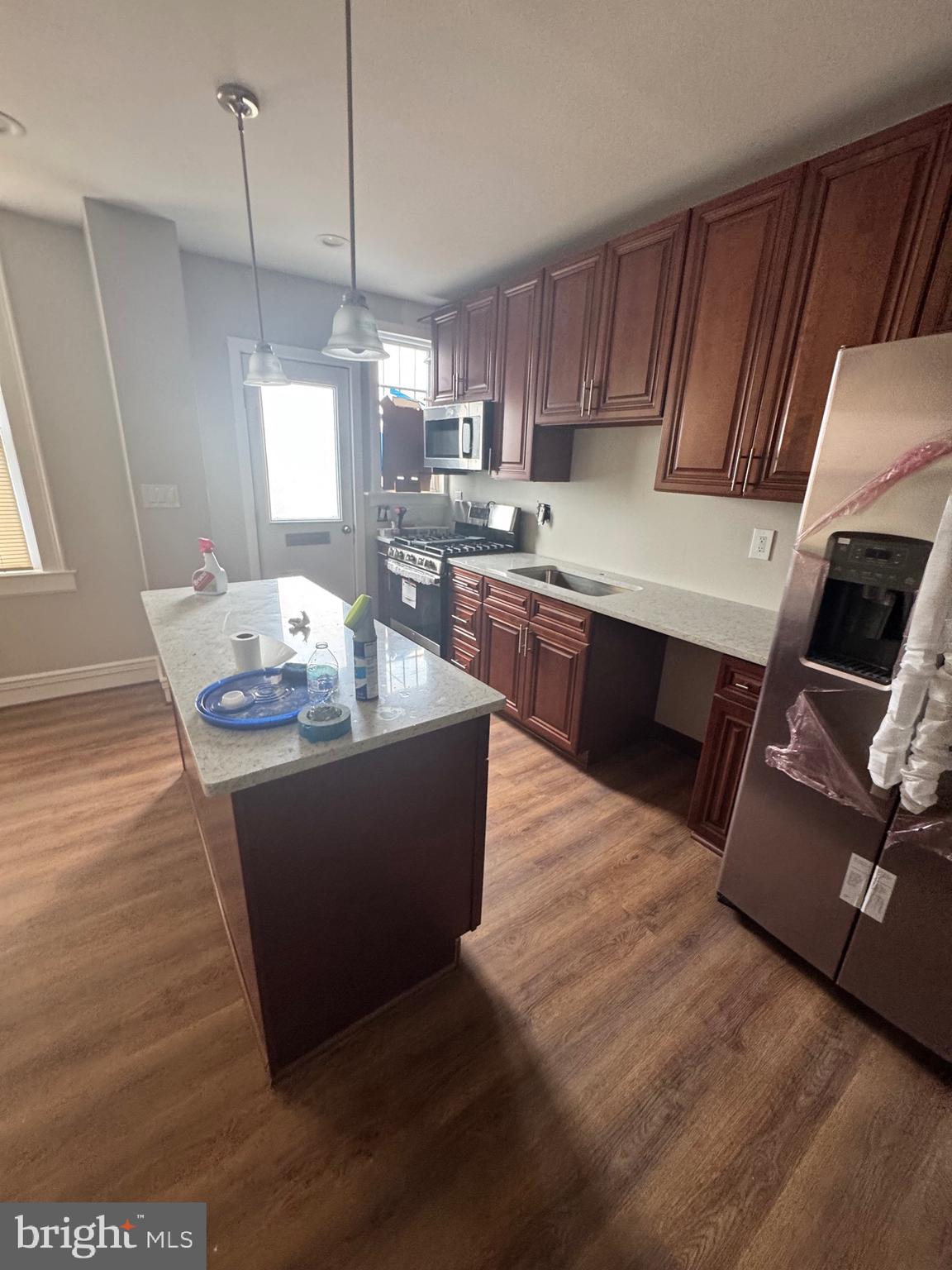 2613 Maisel Street Baltimore, MD 21230 - Photo 4 of 15 a room with wooden floors and kitchen view