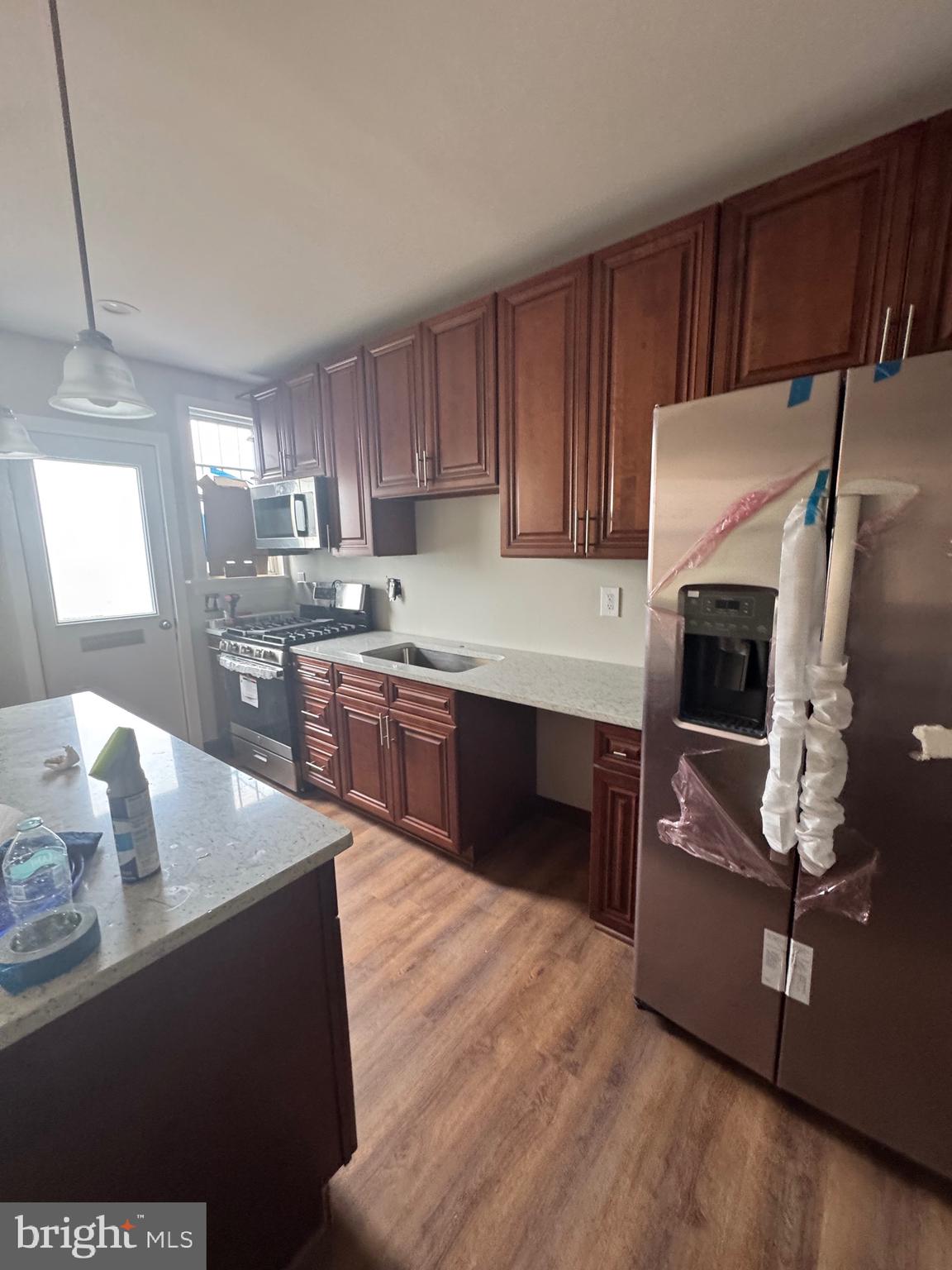 2613 Maisel Street Baltimore, MD 21230 - Photo 5 of 15 a kitchen with stainless steel appliances granite countertop a stove a sink and a refrigerator