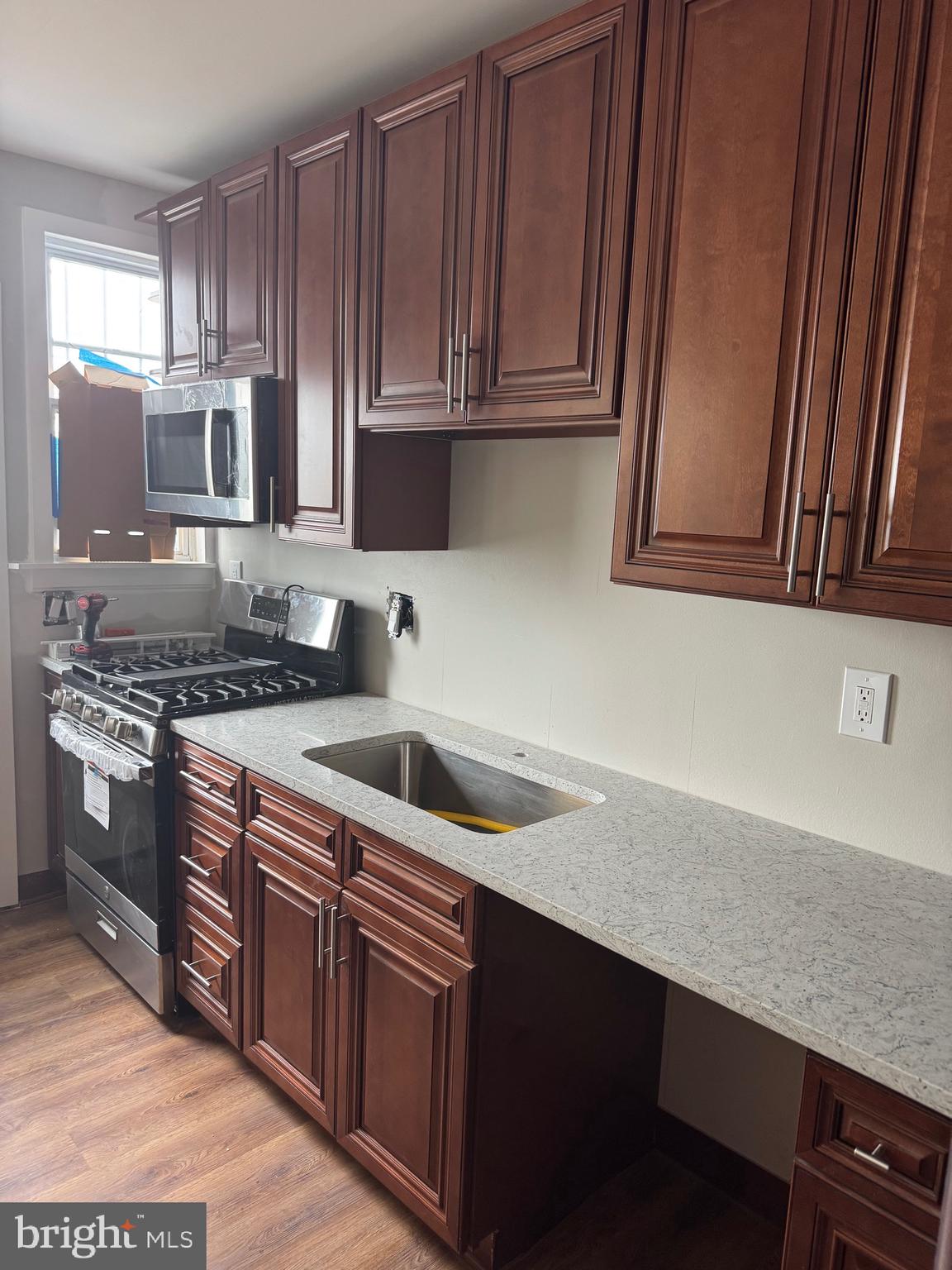 2613 Maisel Street Baltimore, MD 21230 - Photo 6 of 15 a kitchen with stainless steel appliances granite countertop a sink stove and cabinets