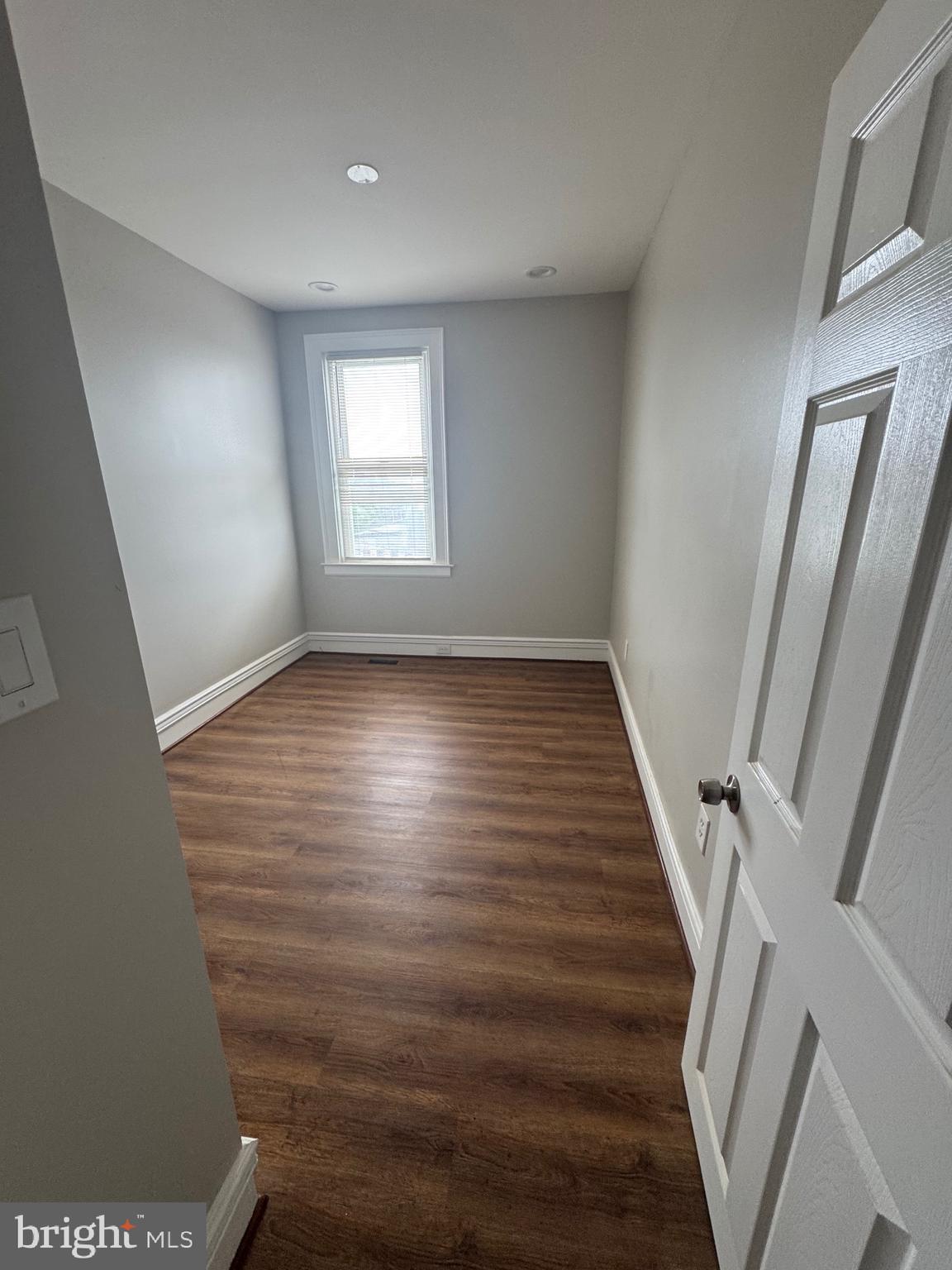 2613 Maisel Street Baltimore, MD 21230 - Photo 10 of 15 a view of an empty room with wooden floor and stairs