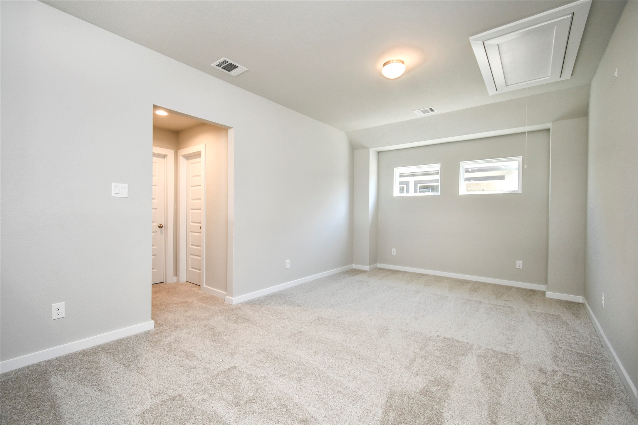 15115 Statice Trail Houston, TX 77044 - Photo 21 of 25 Come upstairs and enjoy a day of leisure in this fabulous game room! This is the perfect hangout spot or adult game room! Features plush carpet, high ceilings, custom paint and windows for plenty of natural light. Sample photo of completed home with similar floor plan. Actual colors and selections may vary.