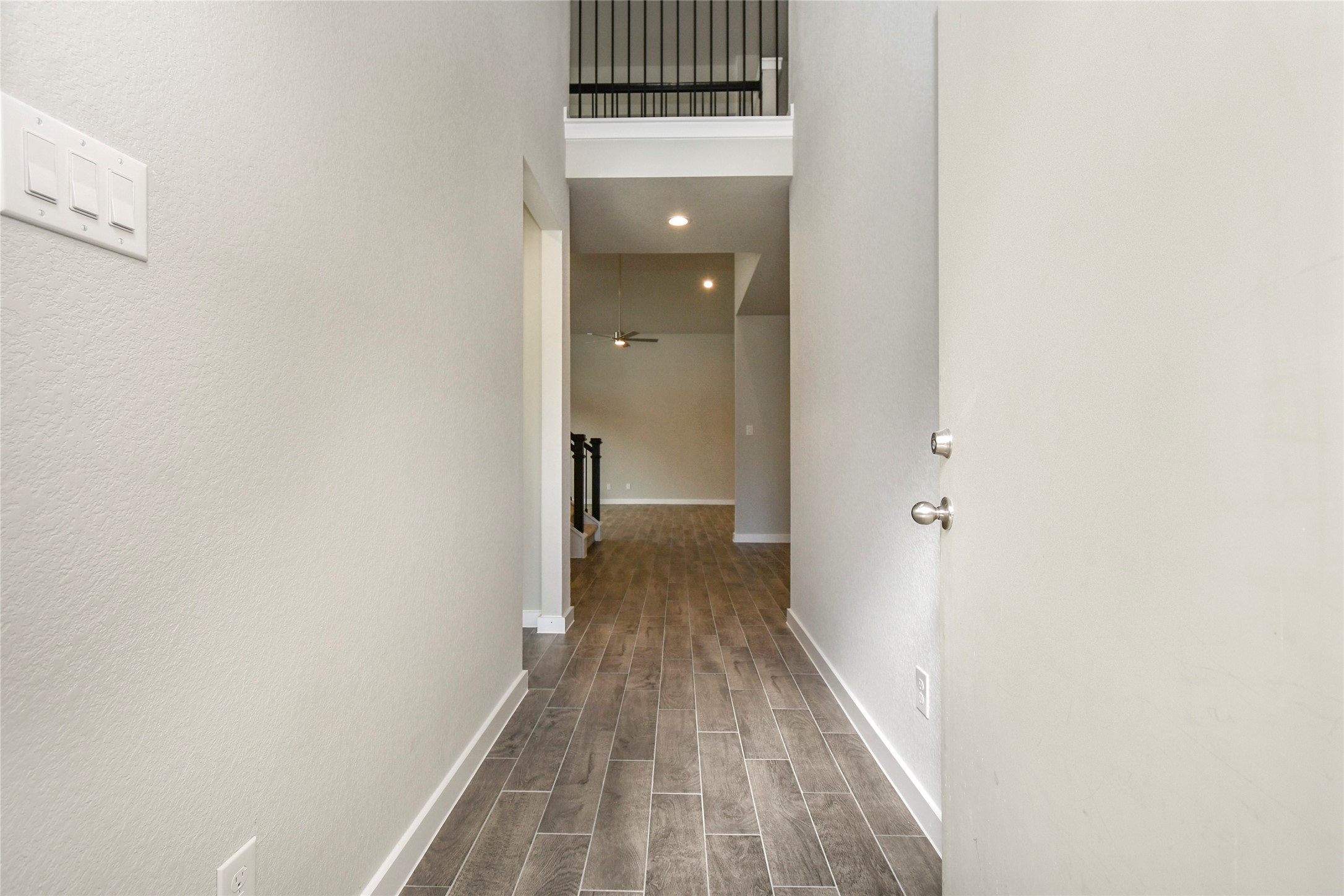 15115 Statice Trail Houston, TX 77044 - Photo 8 of 25 As you step into the threshold of this luxurious home, you'll soon be welcomed by an
elegant glass door (to be installed). Inside, soaring ceilings amplify the spaciousness,
while the refined wood-look tile flooring and oversized baseboards exude
sophistication and charm. Sample photo of completed home with similar floor plan. Actual colors and selections may vary.