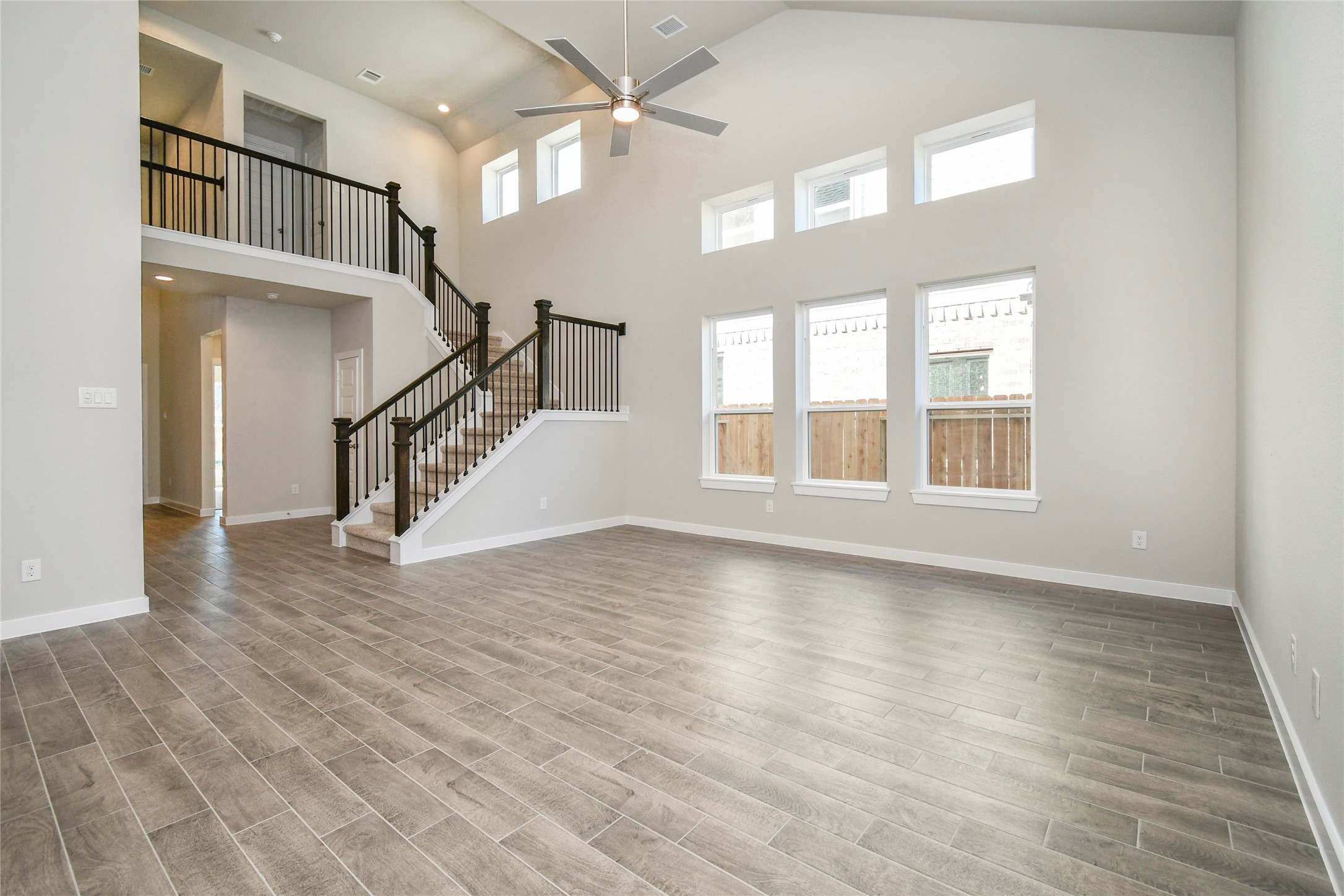 15115 Statice Trail Houston, TX 77044 - Photo 14 of 25 Welcome family and guests to your charming living room! With its high ceilings,
recessed lighting, ceiling fan, custom paint, beautiful flooring, and large windows that let
in abundant natural light, this room is perfect for gatherings. Sample photo of completed home with similar floor plan. Actual colors and selections may vary.