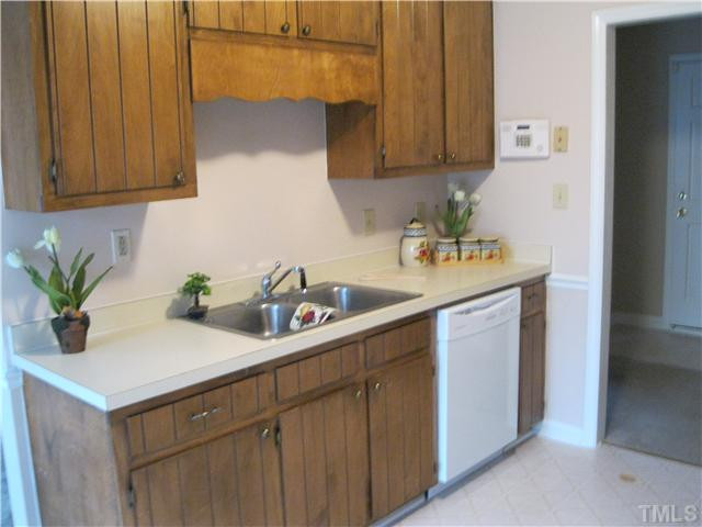 4208 Ferriday Court Raleigh, NC 27616 - Photo 7 of 9 a kitchen with a sink a potted plant and cabinets