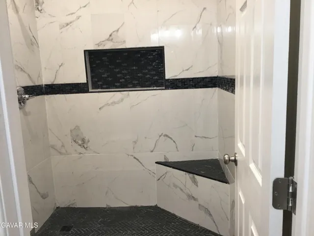 a bathroom with a shower and a sink