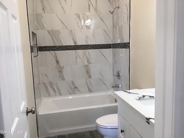 a bathroom with a sink a toilet and a bathtub