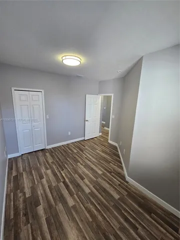 a view of a room with wooden floor and staircase