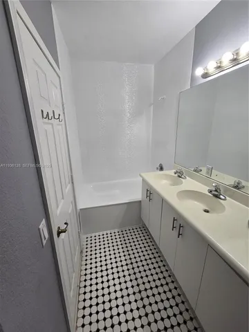 a bathroom with a double vanity sink and mirror