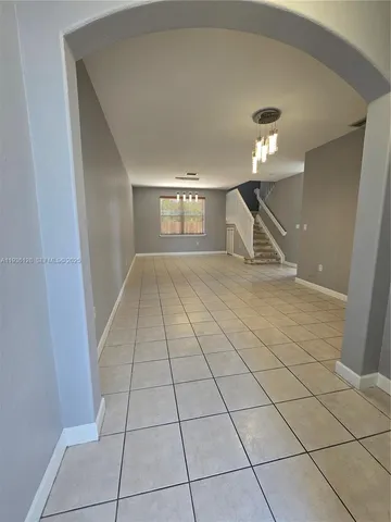 a view of an empty room and a window