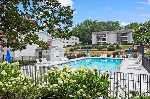 a swimming pool with outdoor seating and yard