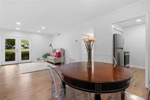 a dining room with furniture and wooden floor