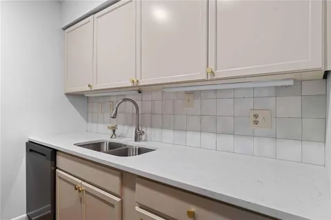 a kitchen with a sink and cabinets