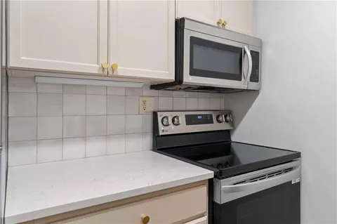 a kitchen with a stove and a microwave
