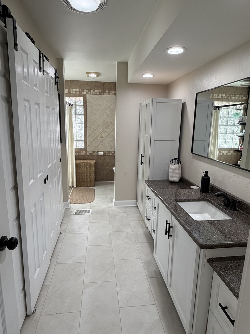 17245 County Line Road Plainfield, IL 60586 - Photo 12 of 45 a large bathroom with a granite countertop tub a double vanity sink a mirror and a shower