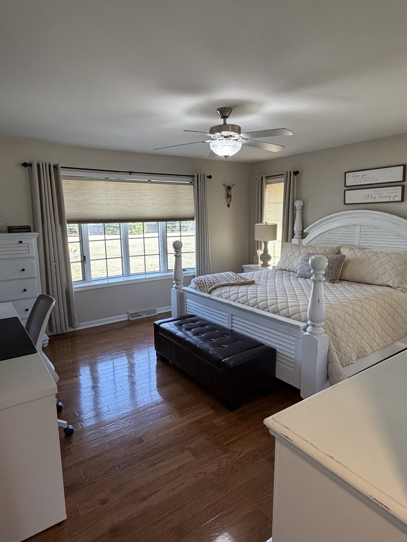 17245 County Line Road Plainfield, IL 60586 - Photo 15 of 45 a bedroom with furniture and a wooden floor