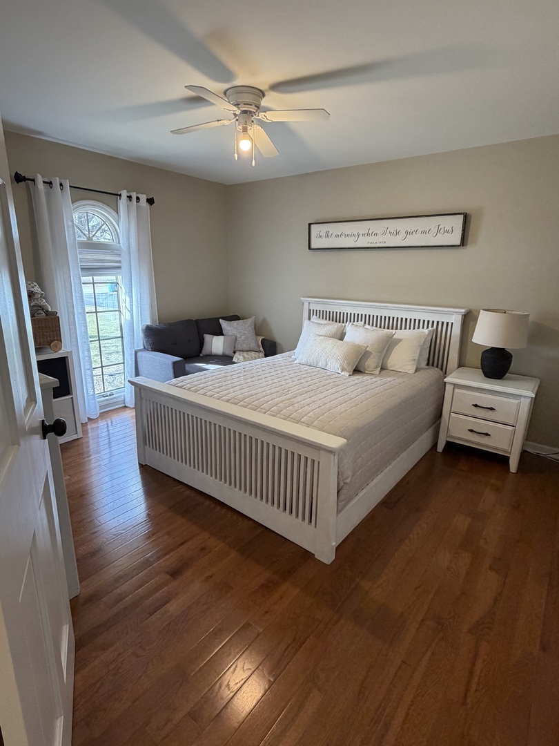 17245 County Line Road Plainfield, IL 60586 - Photo 16 of 45 a bedroom with a bed and a chandelier