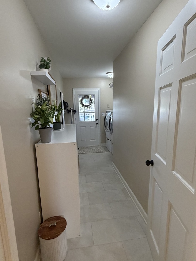 17245 County Line Road Plainfield, IL 60586 - Photo 18 of 45 a view of a hallway to a livingroom with furniture and staircase