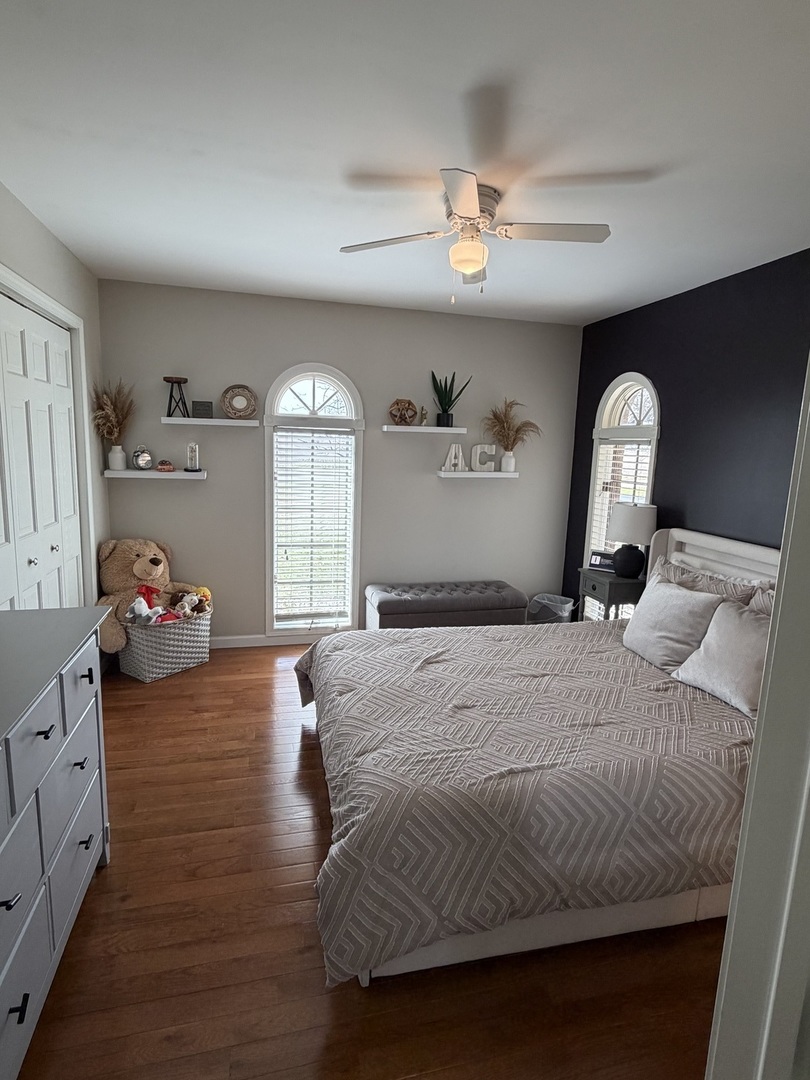 17245 County Line Road Plainfield, IL 60586 - Photo 20 of 45 a bedroom with a bed and a chandelier