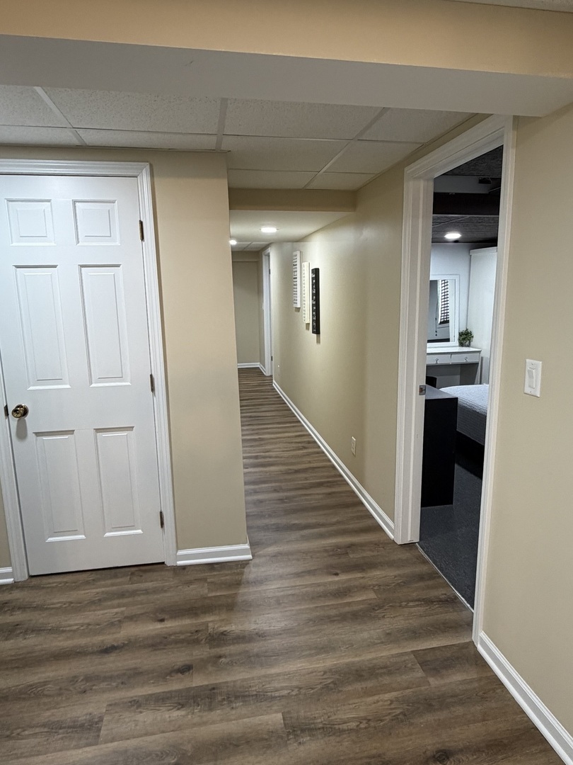 17245 County Line Road Plainfield, IL 60586 - Photo 27 of 45 a view of a hallway with wooden floor and a kitchen