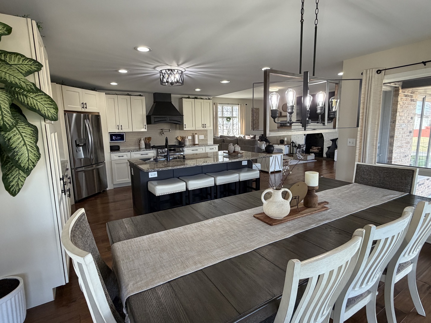 17245 County Line Road Plainfield, IL 60586 - Photo 6 of 45 a kitchen with stainless steel appliances granite countertop sink stove dining table and chairs