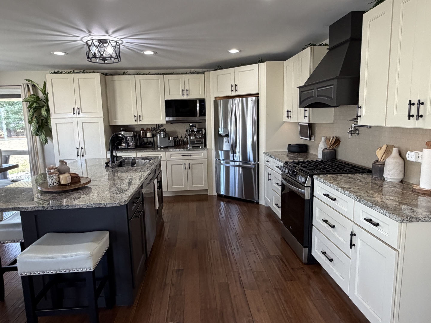 17245 County Line Road Plainfield, IL 60586 - Photo 8 of 45 a kitchen with granite countertop a refrigerator a stove top oven a sink dishwasher and wooden floor