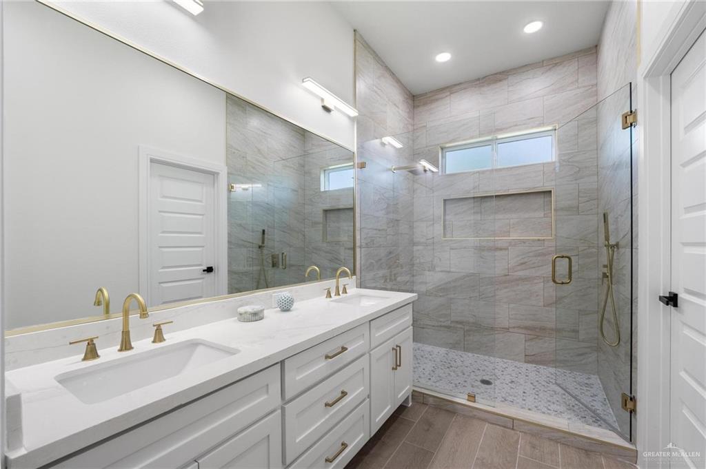 505 Freedom Way Weslaco, TX 78596 - Photo 15 of 20 a bathroom with a double vanity sink mirror and shower