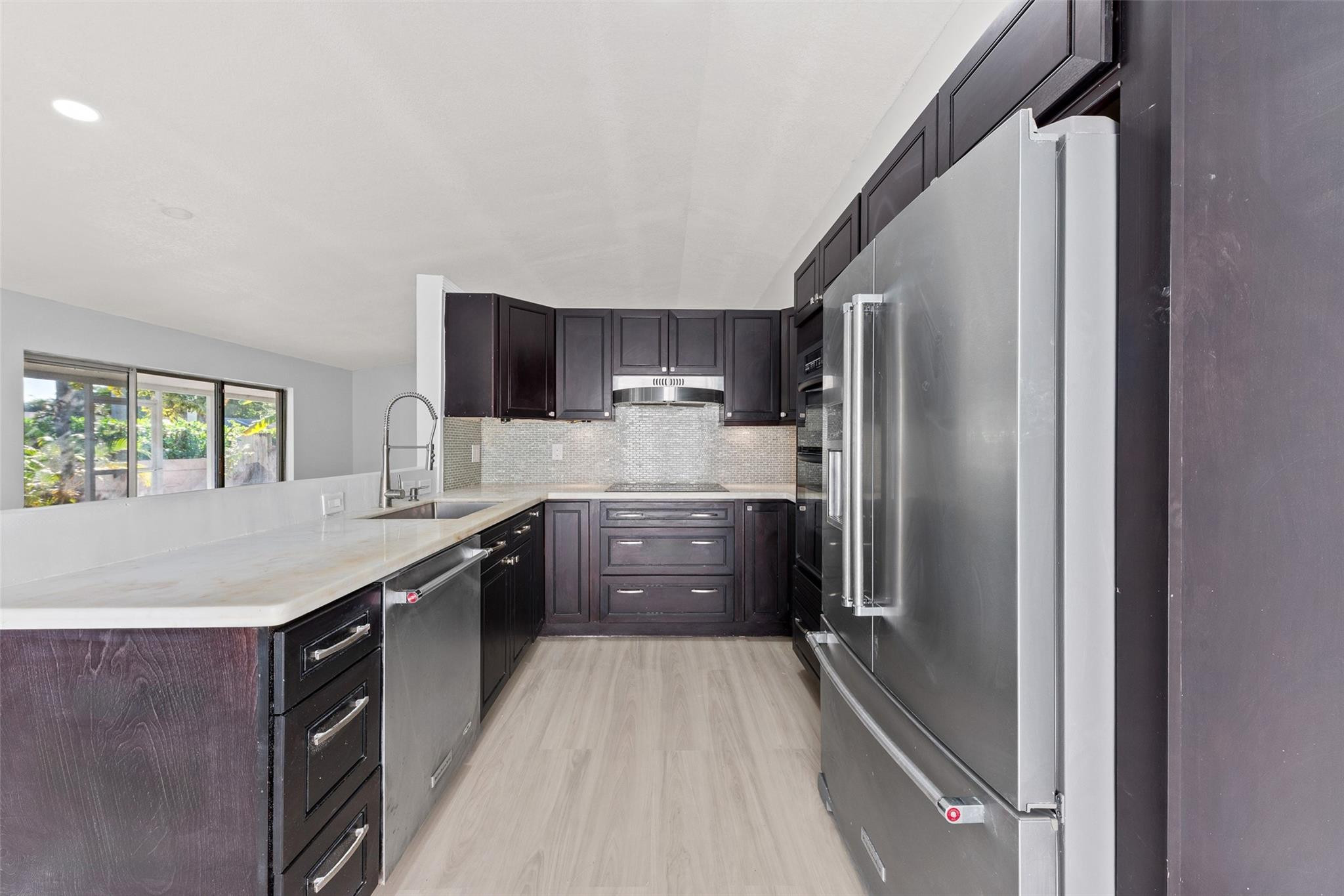 9918 Moss Pond Drive Boca Raton, FL 33496 - Photo 12 of 31 a large kitchen with a large window and stainless steel appliances