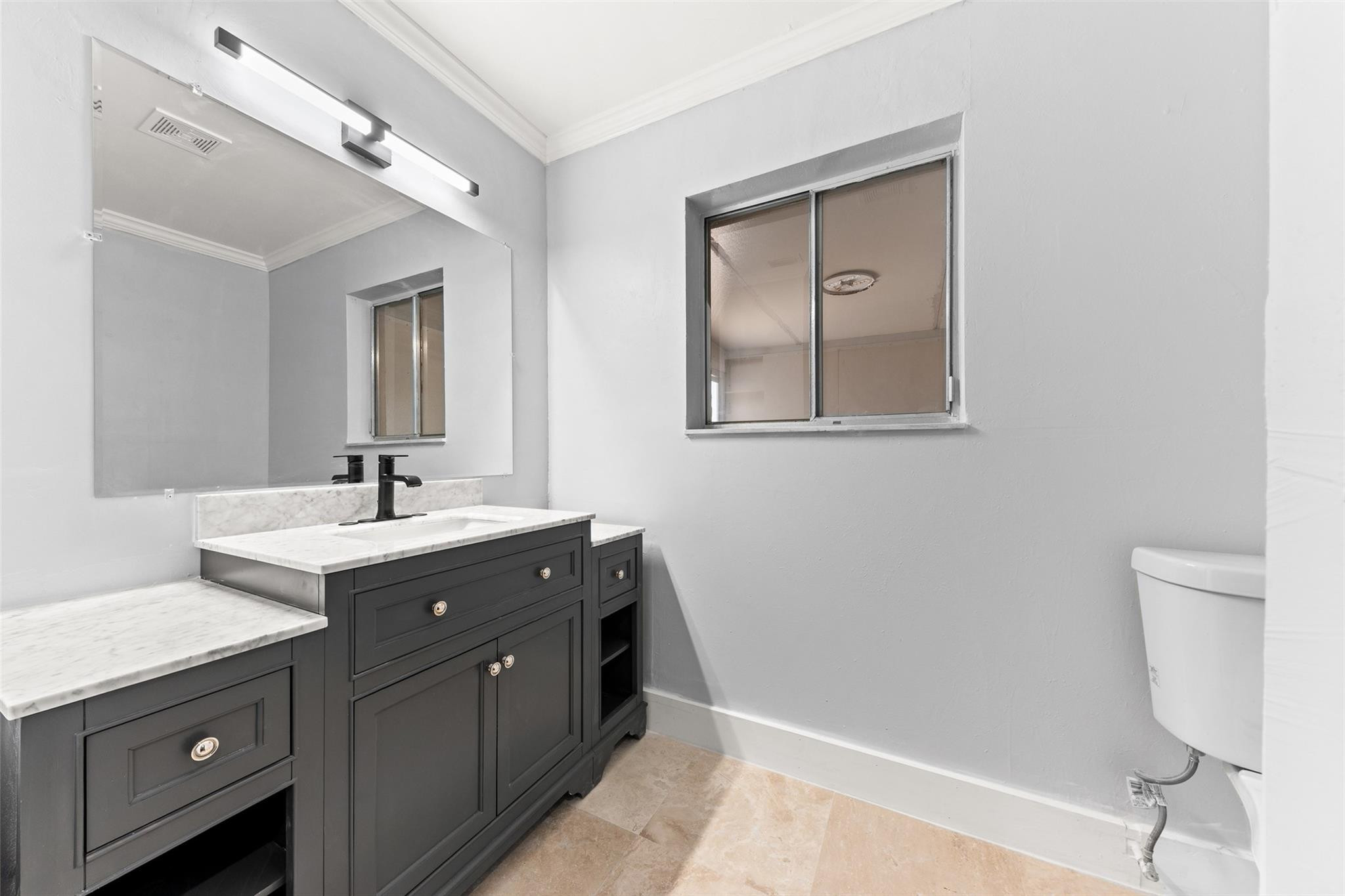 9918 Moss Pond Drive Boca Raton, FL 33496 - Photo 19 of 31 a spacious bathroom with a double vanity sink and a mirror
