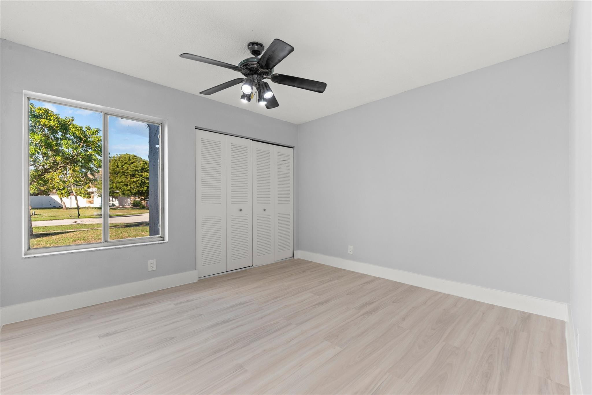 9918 Moss Pond Drive Boca Raton, FL 33496 - Photo 20 of 31 a view of a big room with wooden floor closet and windows