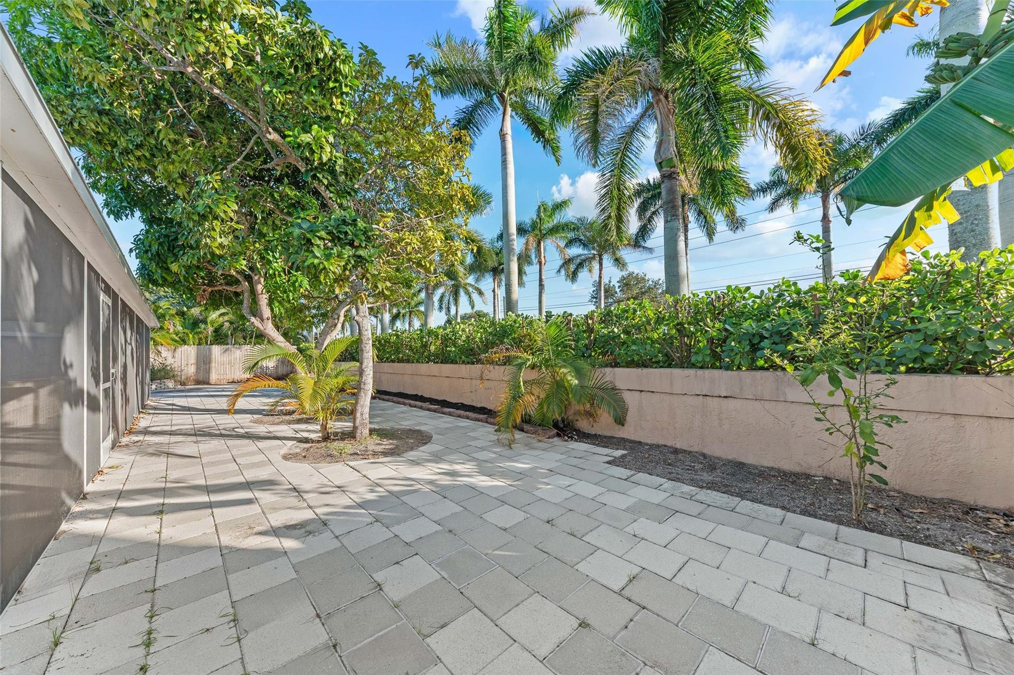 9918 Moss Pond Drive Boca Raton, FL 33496 - Photo 27 of 31 a view of a yard with plants and a chair