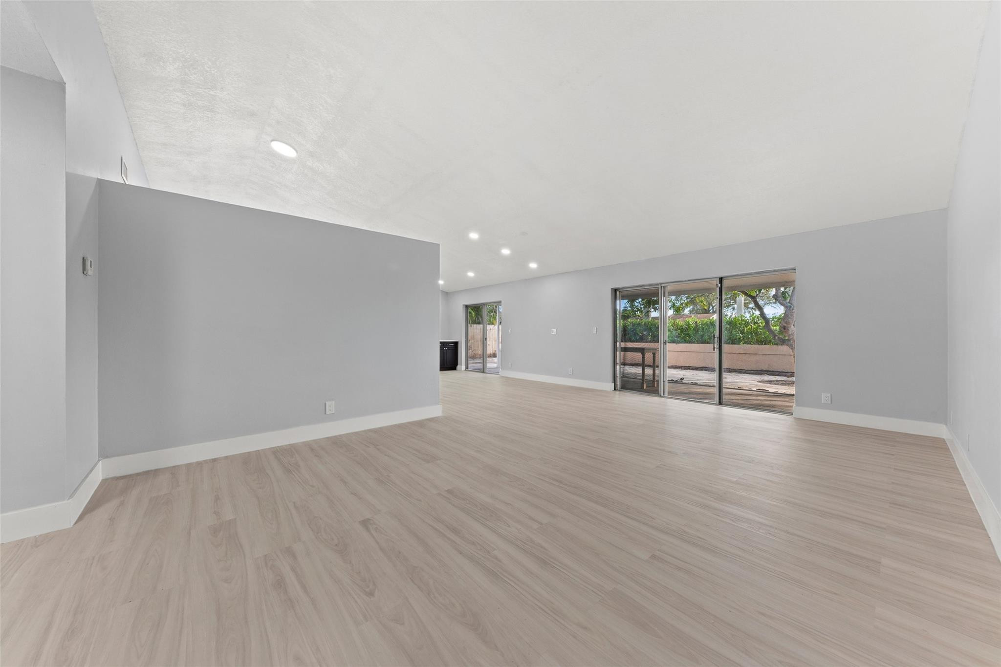 9918 Moss Pond Drive Boca Raton, FL 33496 - Photo 4 of 31 wooden floor in an empty room with a window