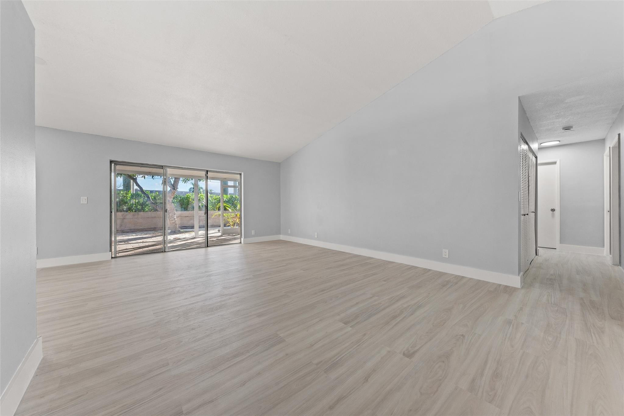 9918 Moss Pond Drive Boca Raton, FL 33496 - Photo 5 of 31 wooden floor in an empty room with a window