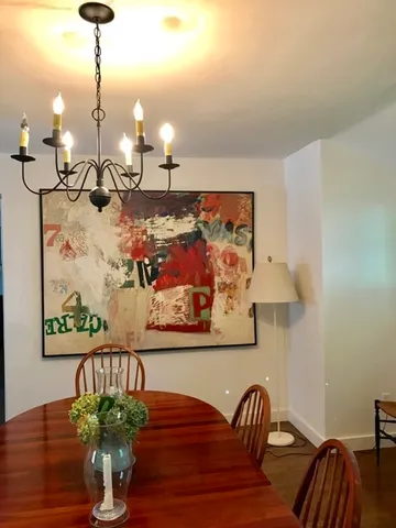 a dining room with furniture and wooden floor