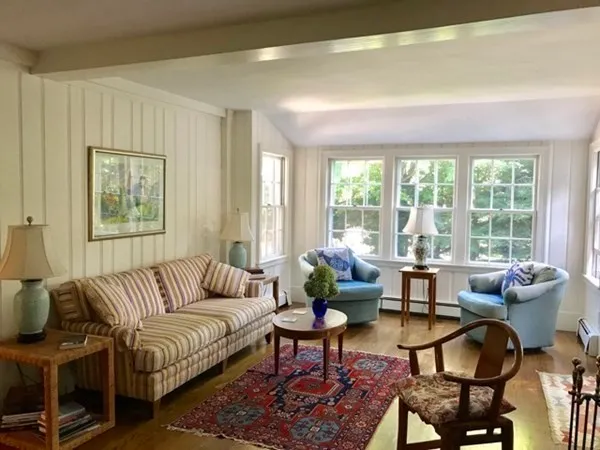 a living room with furniture and large windows