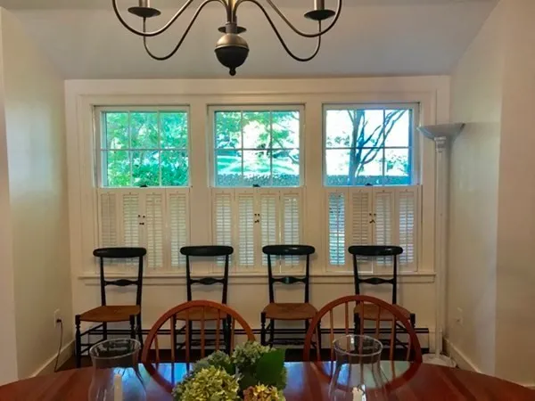 a table with chairs in front of a window