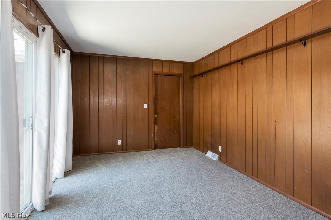 6484 State Road Parma, OH 44134 - Photo 15 of 36 Comfortable family room with carpeting and decorative wall paneling.